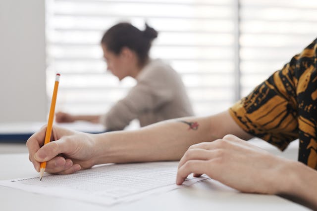 A student taking a test at a desk