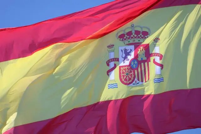 Spanish flag waving on a clear, sunny day