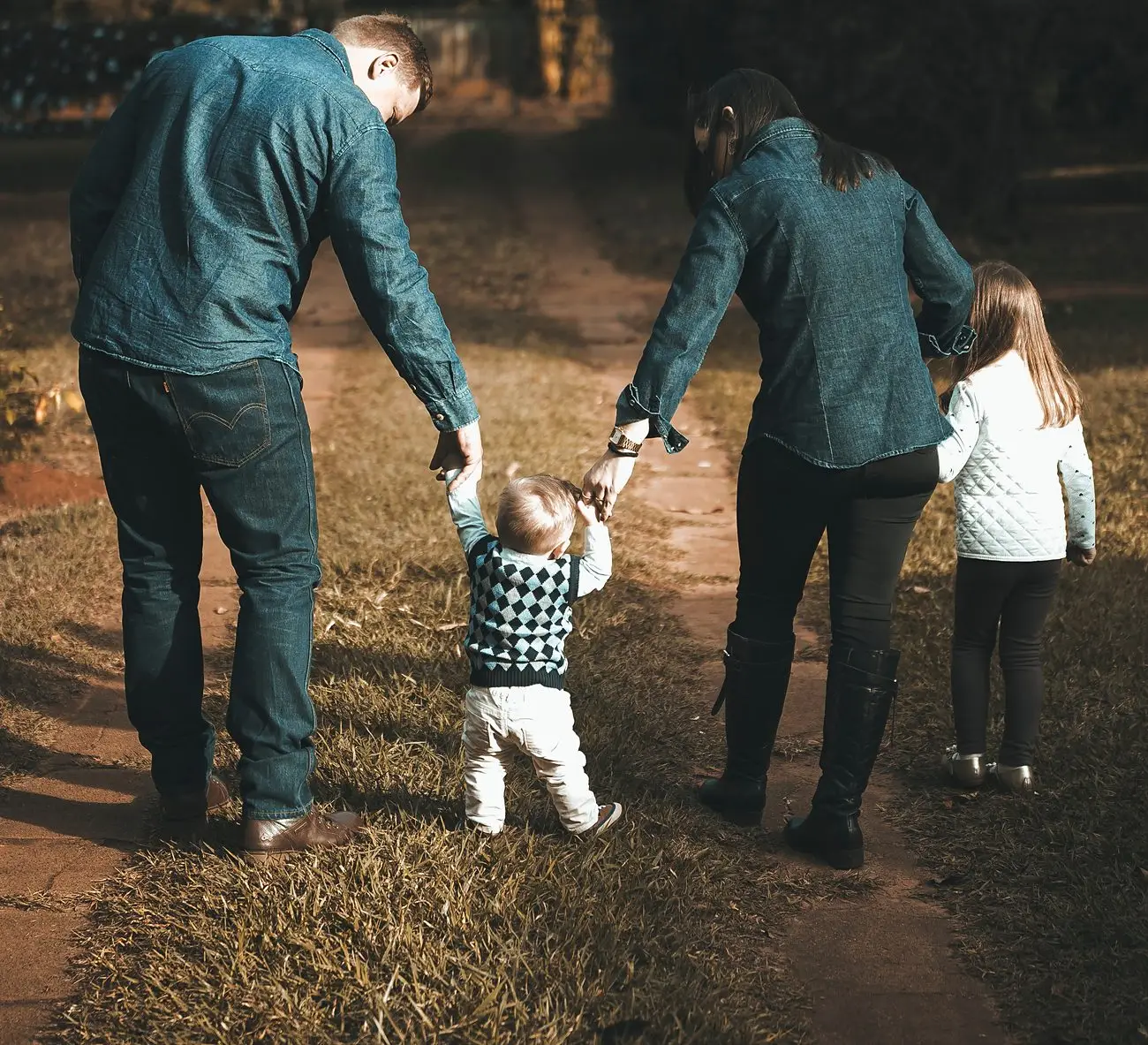 Parents walking hand in hand with their two children