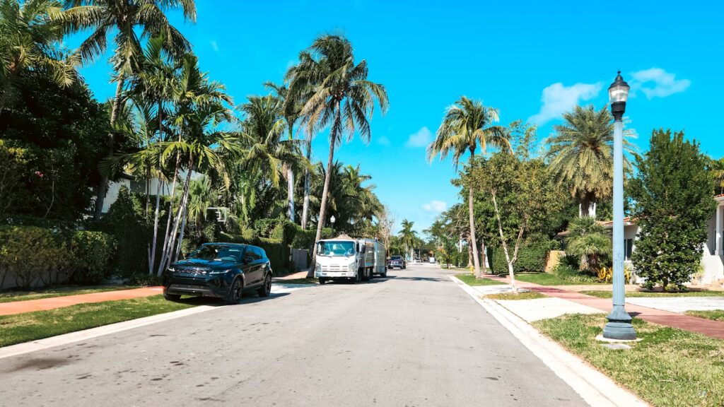 A palm-lined residential street in Miami, where the neighborhood a family chooses shapes which school programs they can reach.
