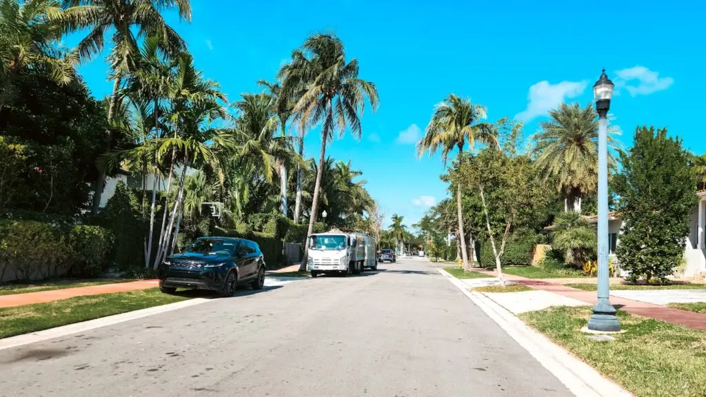 A palm-lined residential street in Miami, where the neighborhood a family chooses shapes which school programs they can reach.