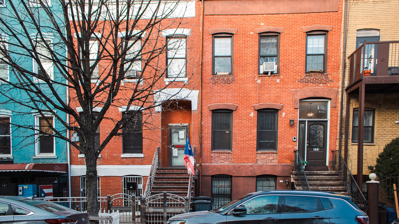 A row of New York townhouses on a residential street, where the school a child attends depends on more than the address.