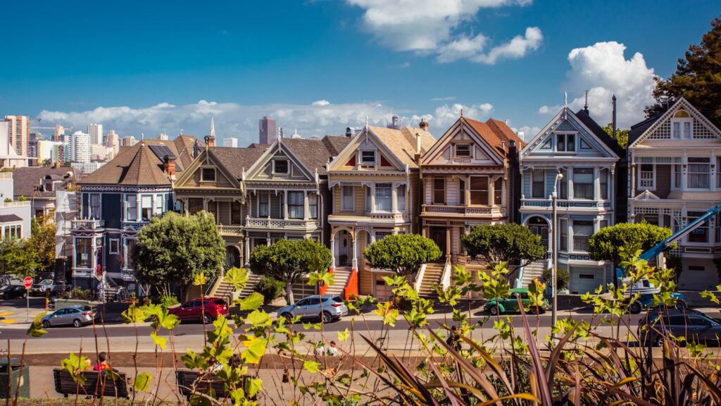 A residential street of two-story San Francisco houses, where children on the same block may attend very different schools.