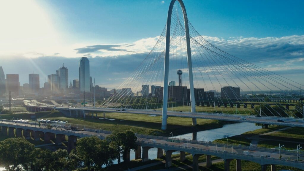 Sunrise over the Margaret Hunt Hill Bridge and the Dallas skyline, the setting for a look at the current education landscape in Dallas.