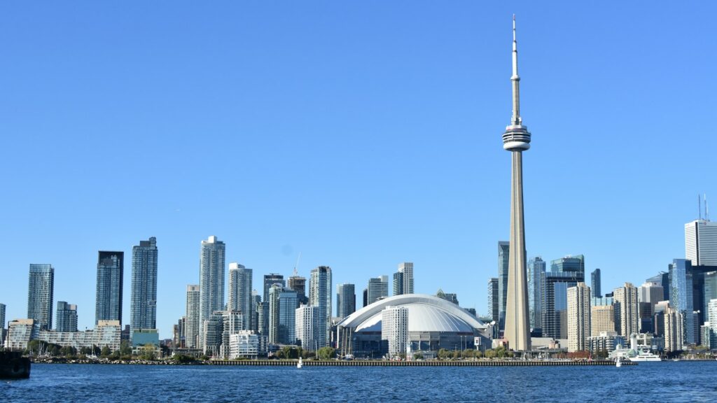 The Toronto skyline and CN Tower seen from Lake Ontario on a clear blue-sky day.