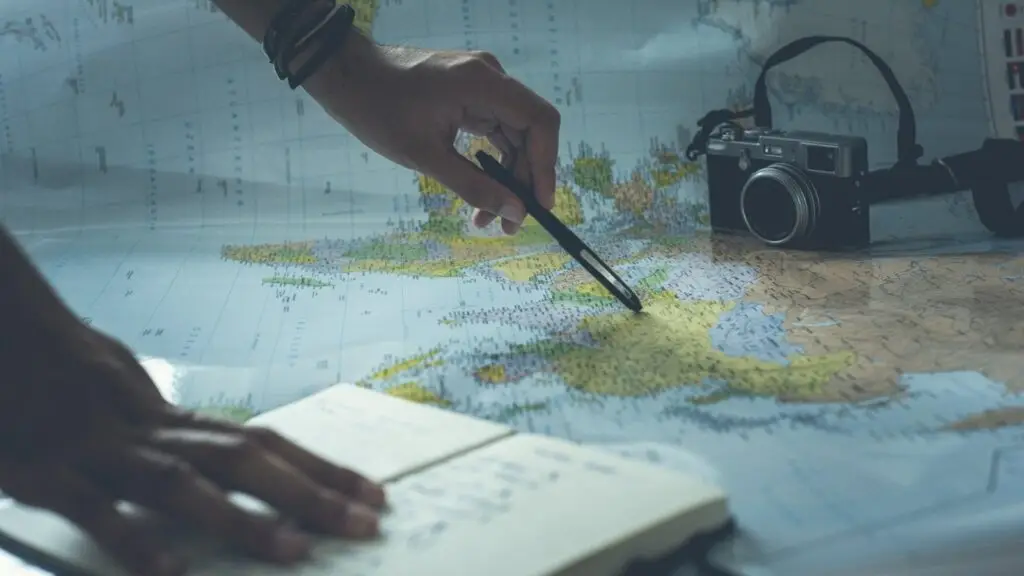 A pen pointing to a location on a map during research