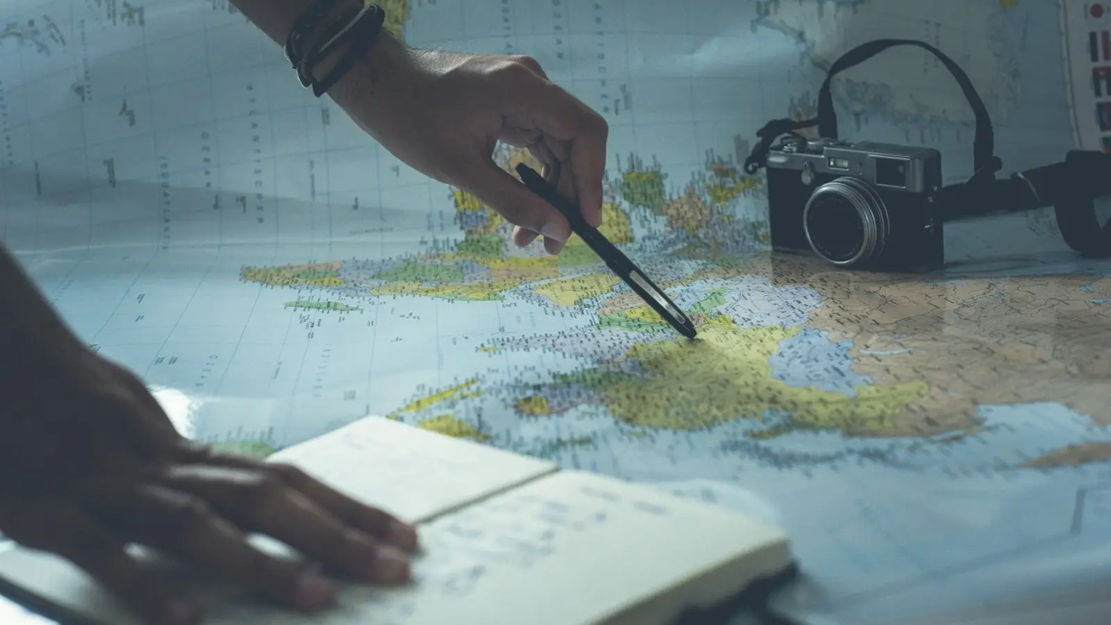 A pen pointing to a location on a map during research