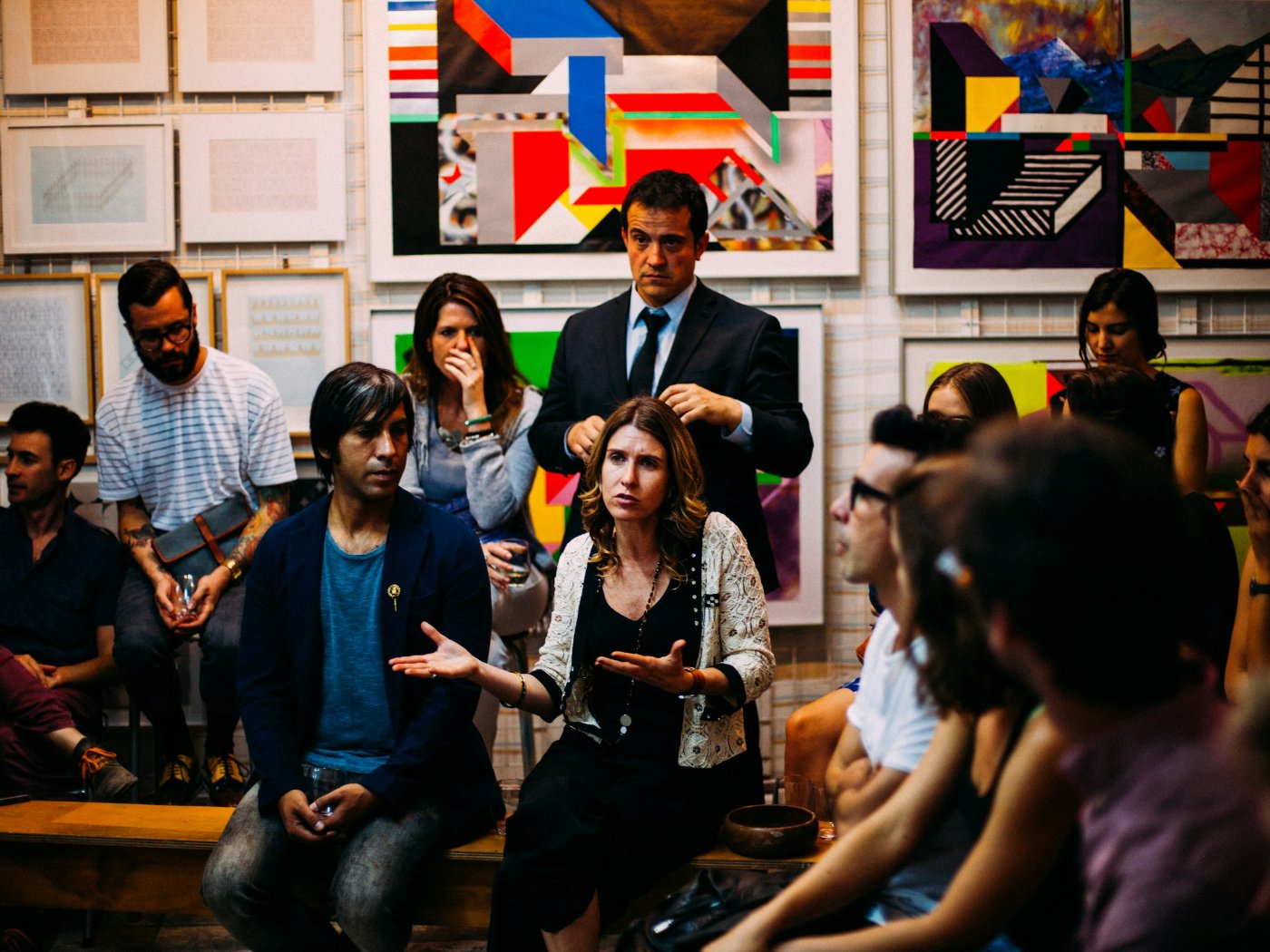 A group of adults in discussion during a meeting in a bright room