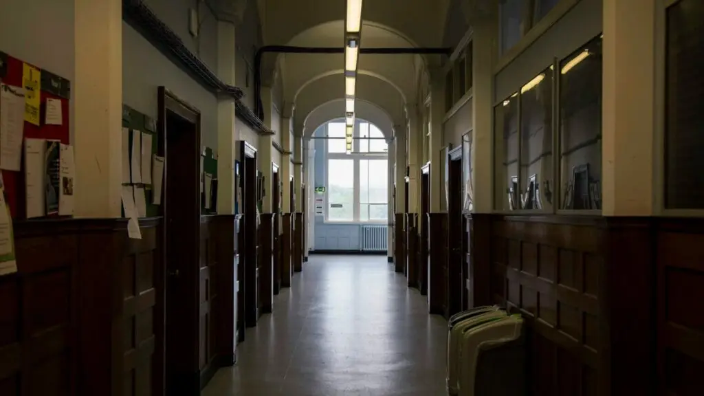 A long school hallway with arched windows