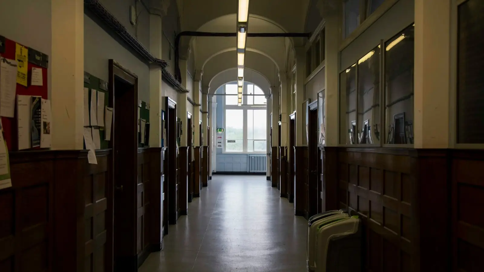 A long school hallway with arched windows