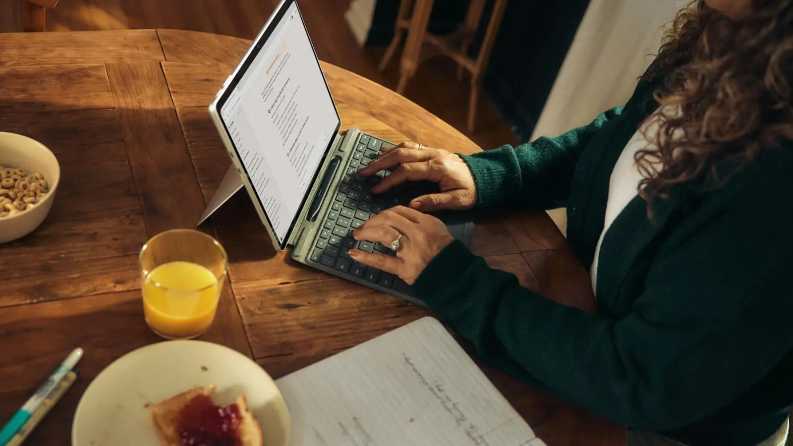A person working on a laptop at a table at home