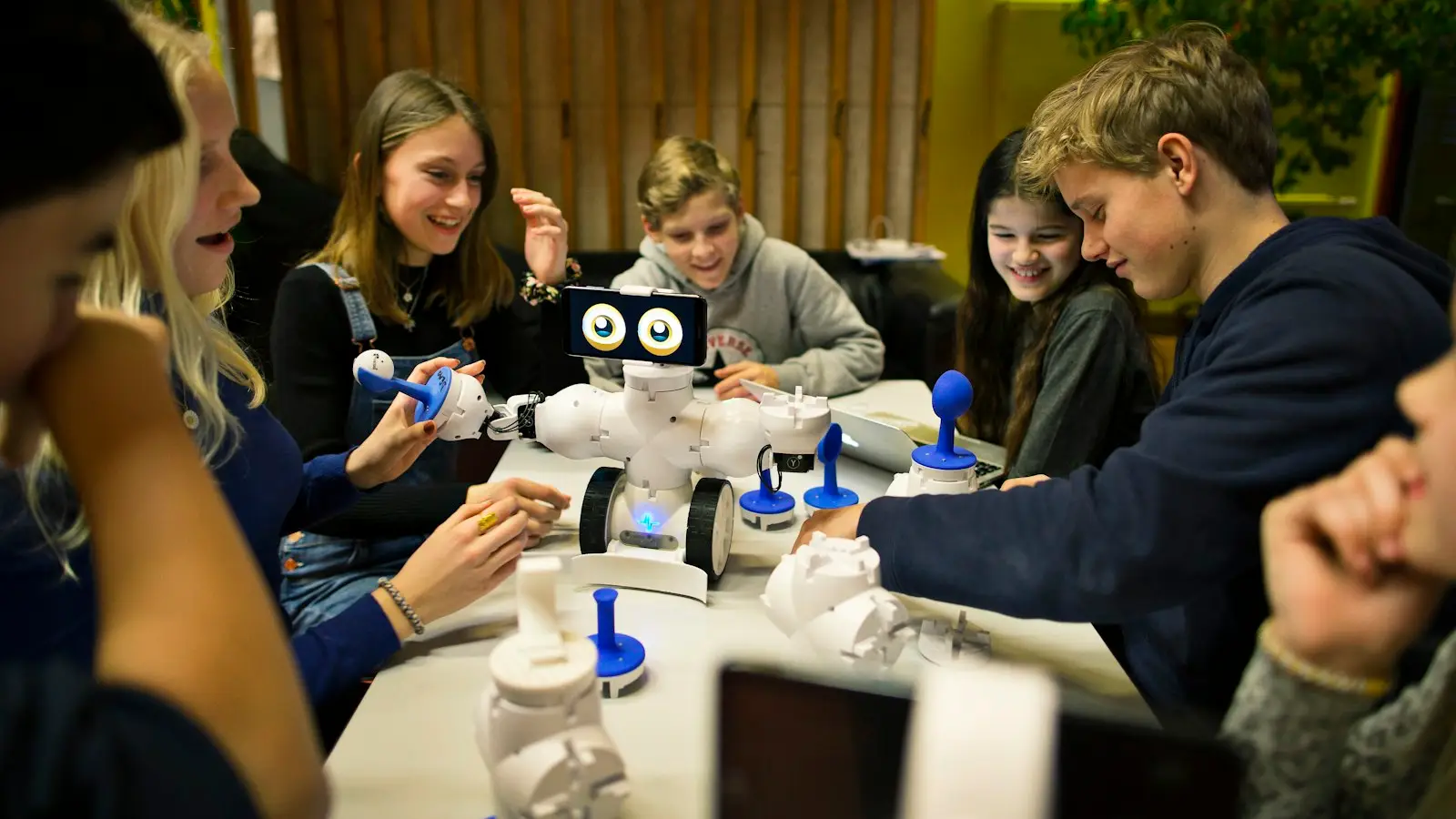 Secondary students work together on a classroom robot; magnet and choice programs in the Dallas area admit by application rather than by address.