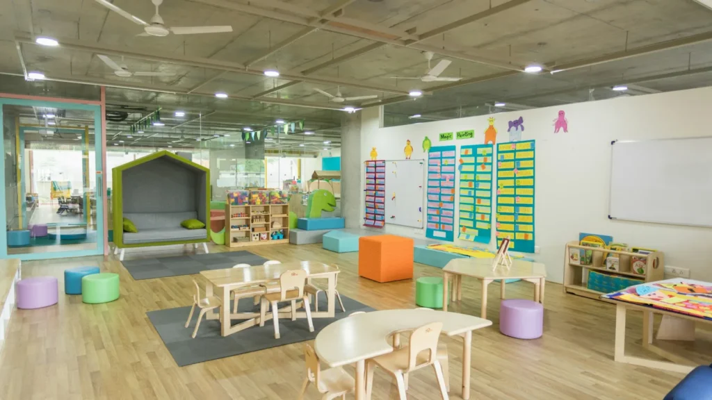 A bright early years classroom with small tables and chairs
