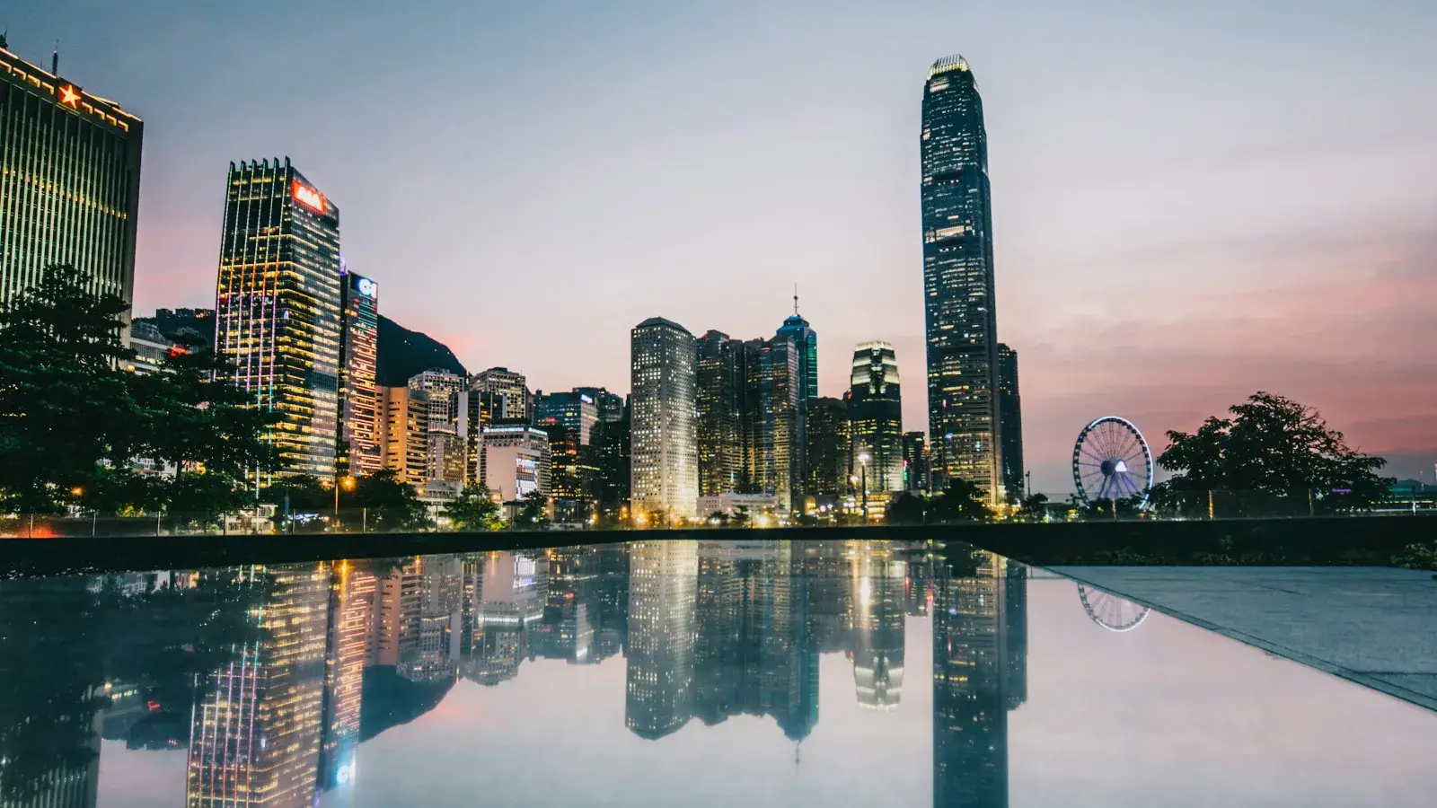 The Hong Kong skyline reflected in a still pool at dusk