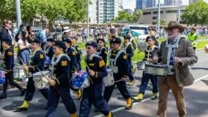 A school marching band with an Australian flag in an Australia Day parade